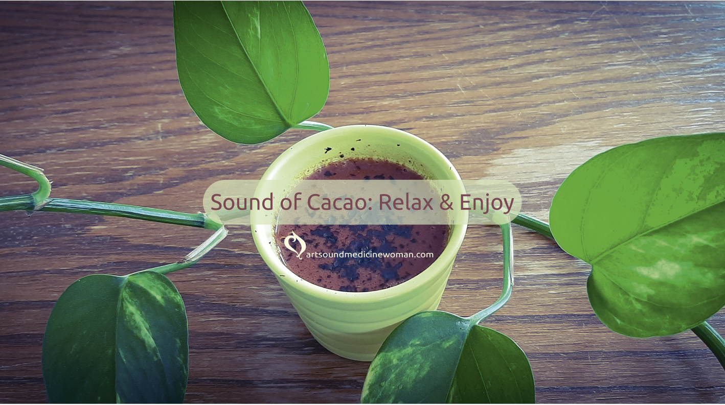 Small cup of ceremonial cacao surrounded by a vine of Pothos showing its green leaf. It is setting the atmosphere for a Sound of Cacao ceremony. Theme of the ceremony is Relax & Enjoy.