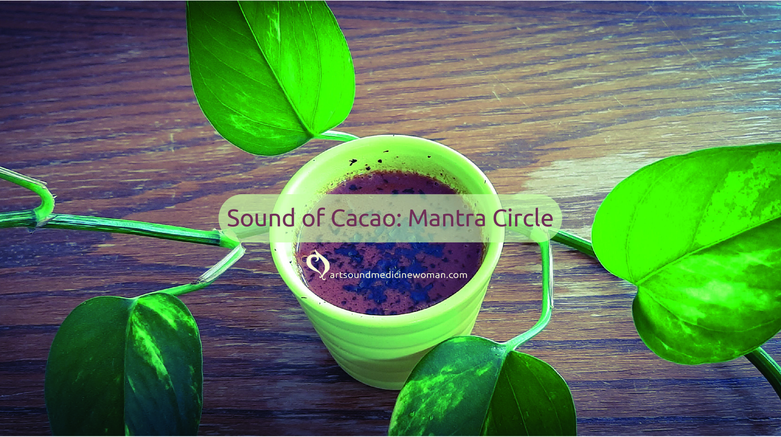 Small cup of ceremonial cacao surrounded by a vine of Pothos showing its green leaf. It is setting the atmosphere for a Sound of Cacao ceremony. Theme of the ceremony is Mantra Circle.